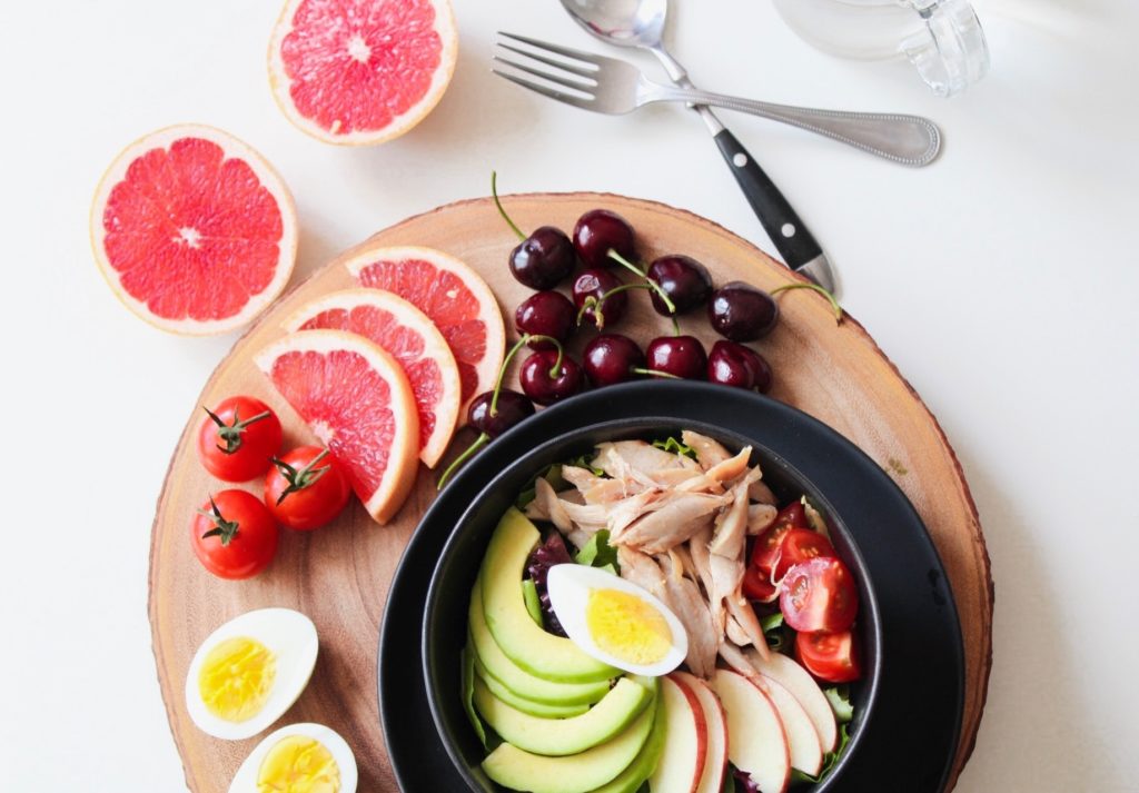 bowl of vegetable salad and fruits 936611